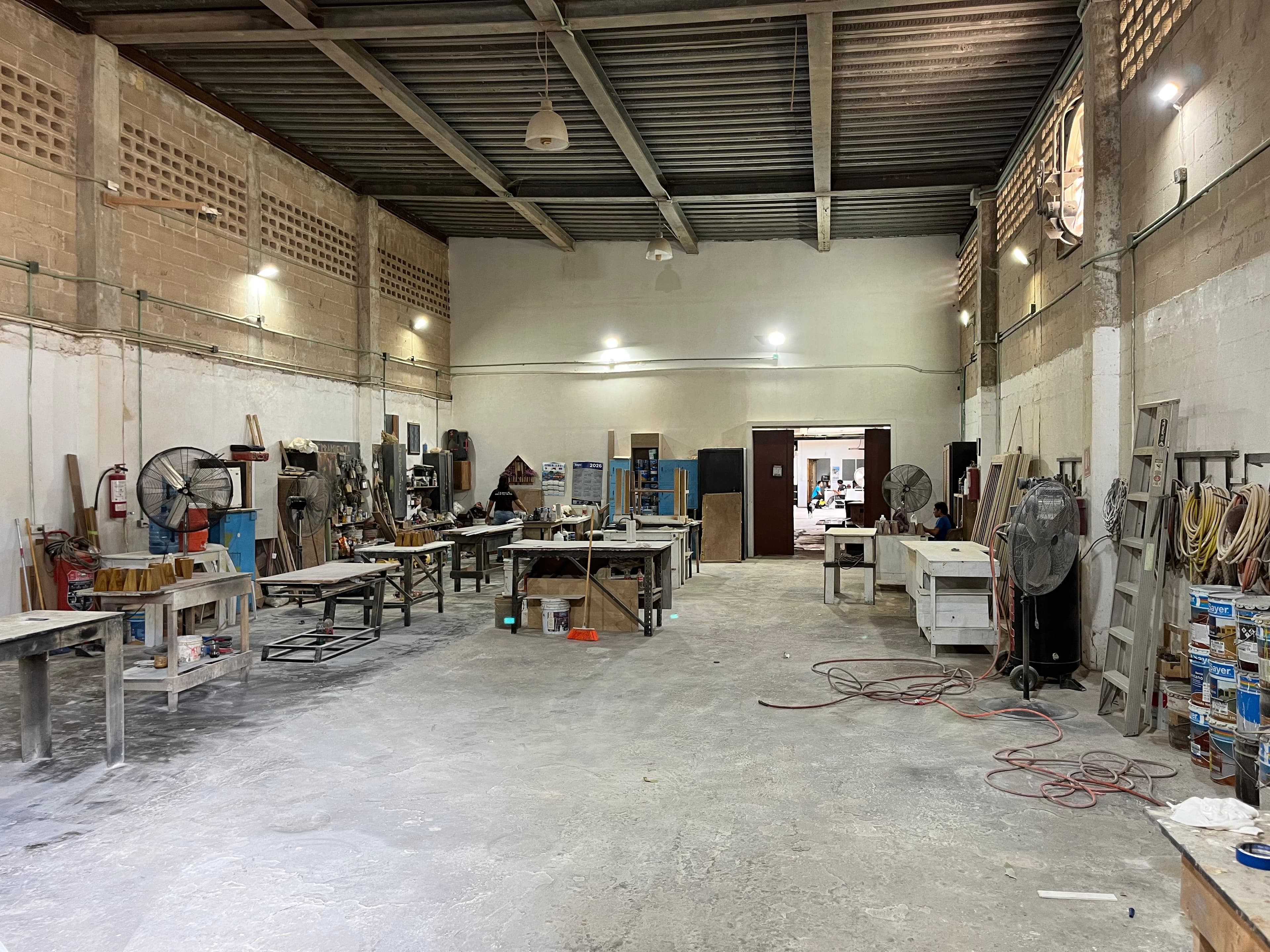 Wood 4 U manufacturing facility — production floor with work benches and millwork in progress, Cancún